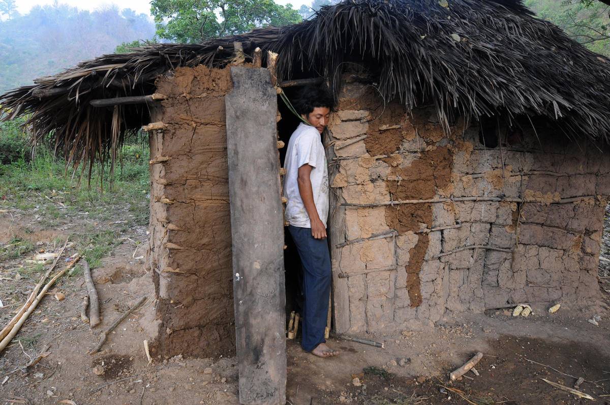 hut montana A man squeezes through the doorway of his hut in Montana.