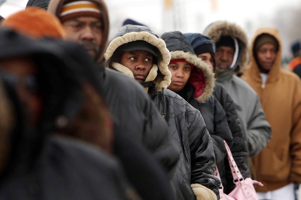 line In Detroit, people wait in line to receive food.