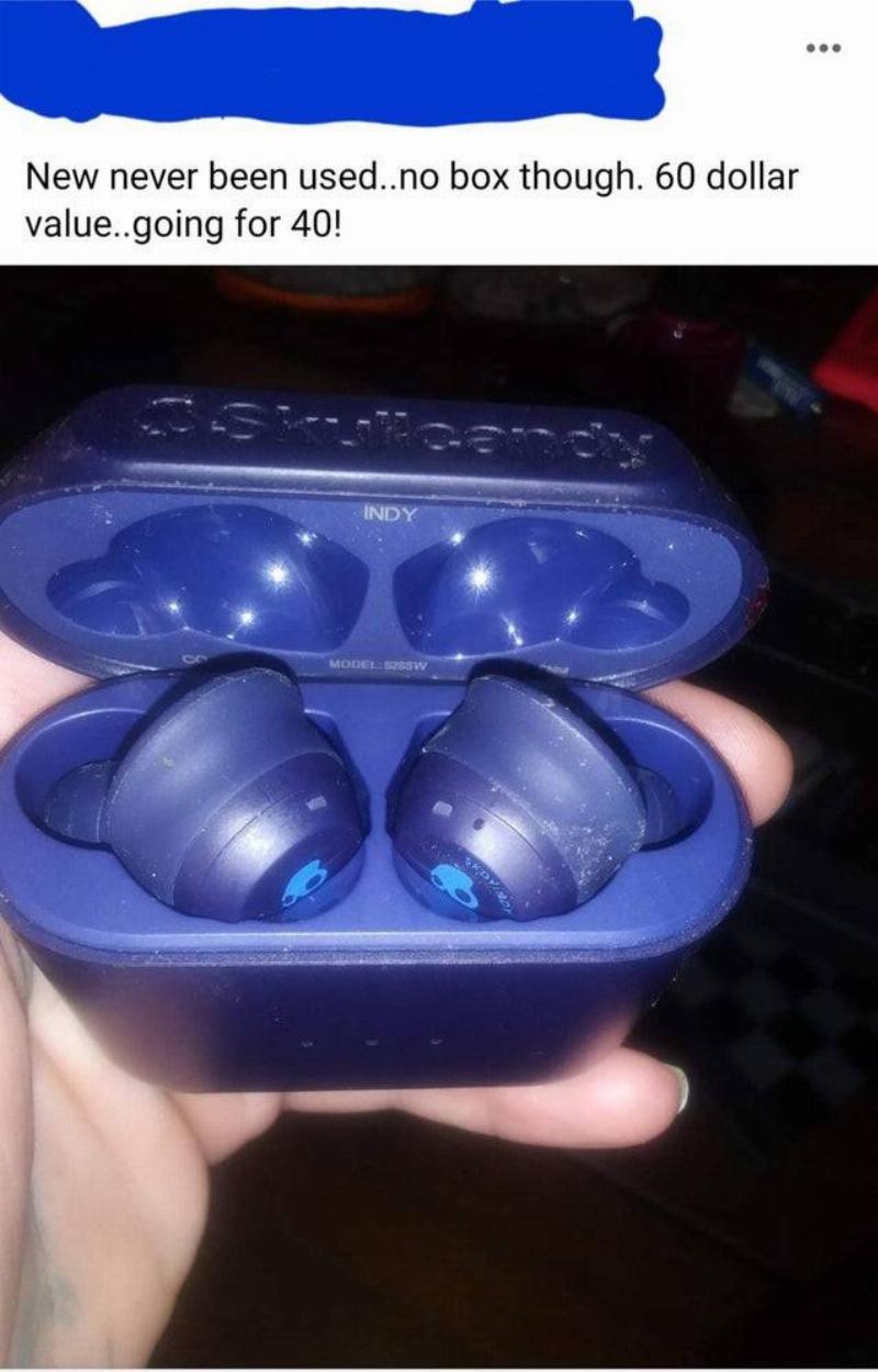 A pair of ear buds are for sale with ear wax still on them.