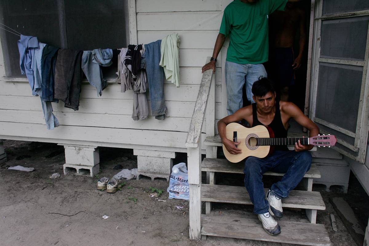 north carolina In North Carolina, an impoverished man plays guitar on his front porch.