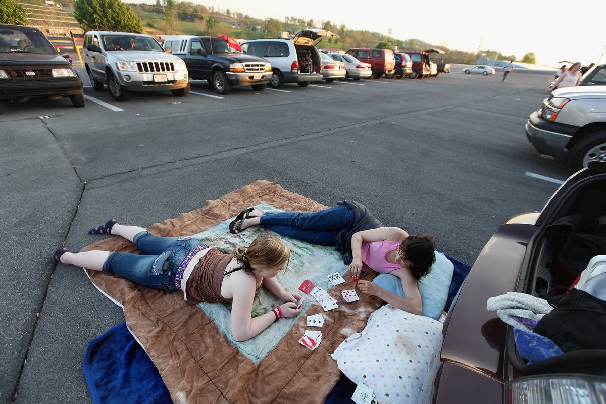 parking lot Two women wait in a parking lot to receive medical attention in Tennessee.