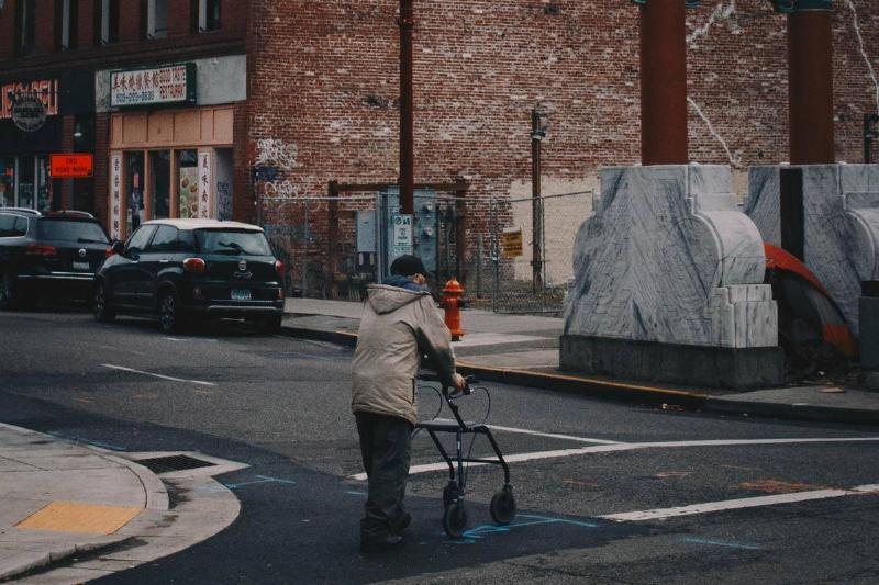 poverty portland In Portland, OR, a homeless man walks across the street.