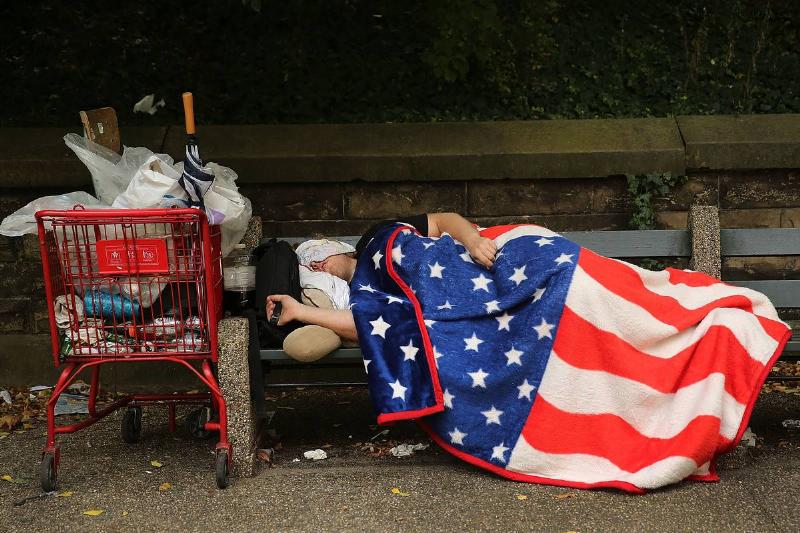 sleeping homeless A homeless man in New York sleeps with an American flag blanket.