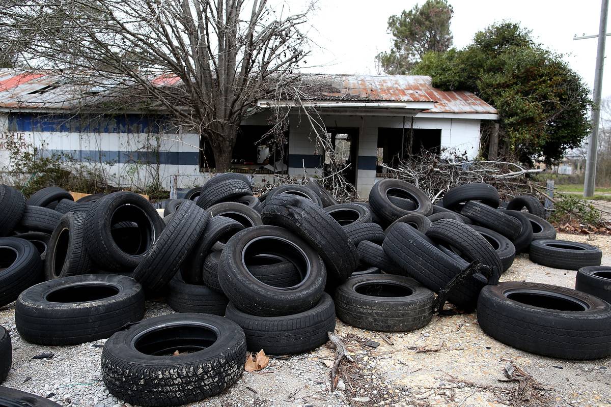 tires IN Selma, AL, a pile of tires sits in front of a poor autoparts shop.