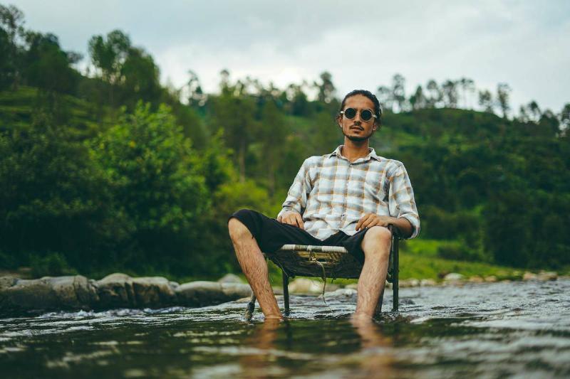 armrest a man sitting in a chair in the water