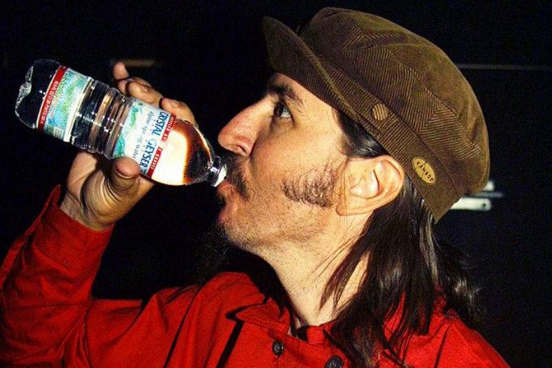 crystal geyser 104846060 Les Claypool drinking a bottle of crystal geyser water