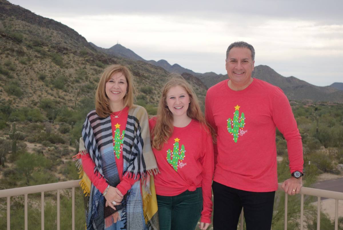 The Cartellones wear matching sweaters in this photo.