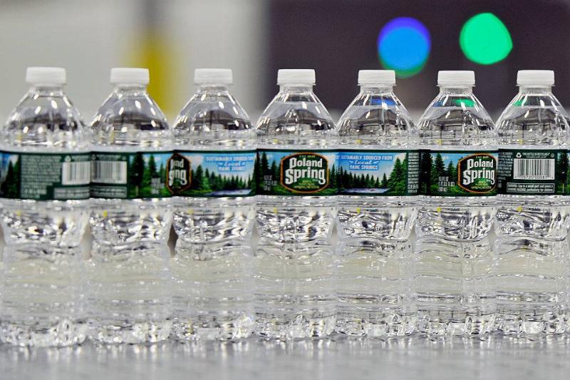 poland spring 543299208 Bottles of Poland Spring water on a conveyer belt