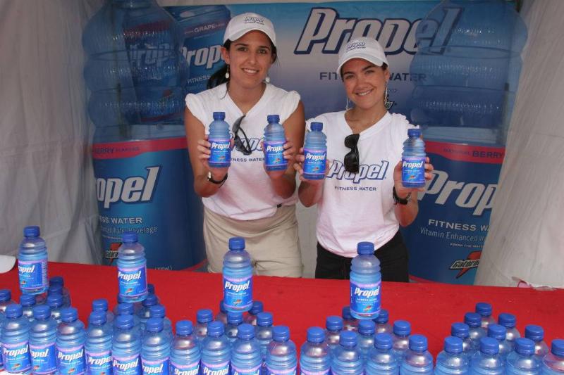 propel 929127006 Two women handing out free Propel bottled fitness water