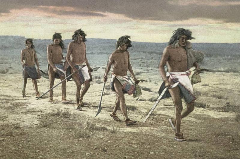 ancient hunters A line of ancient people travel to hunt.