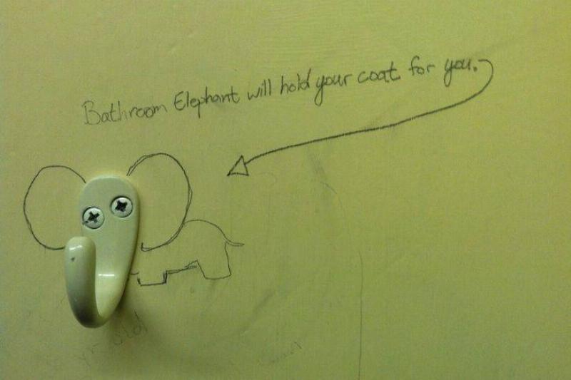 Public bathroom graffiti: bathroom elephant will hold your coat for you, and an arrow to the coat hanger which has been drawn to look like an elephant's trunk