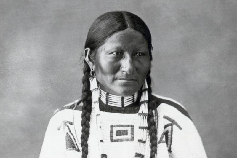native woman Brule-Teton Sioux woman wears traditional clothing in this photo.
