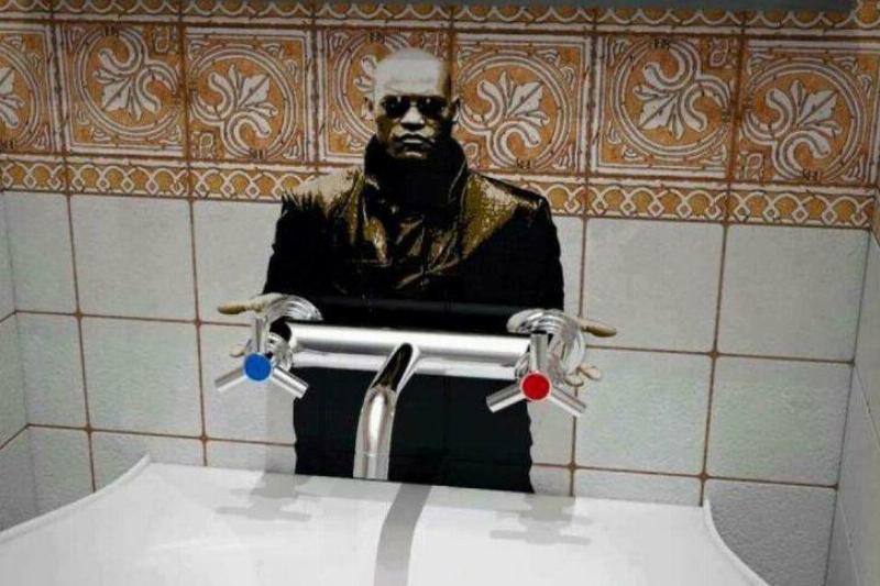 red or blue Public bathroom graffiti: Morpheus cutout attached to taps with blue (for cold water) and red (for hot water)
