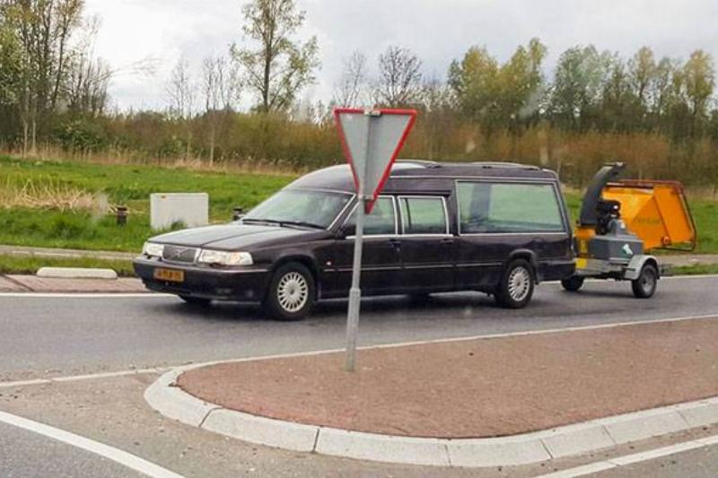 hearse towing a wood chipper