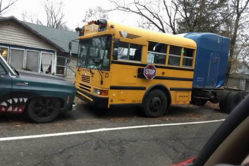 front half of a school bus attached to a truck