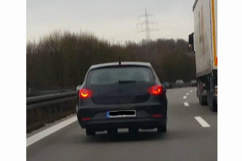 a car on the highway with what appear to be extra wheels underneath