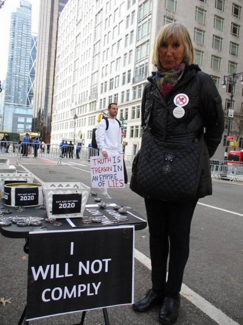 Table Karen Woman standing beside table with sign saying they will not comply.