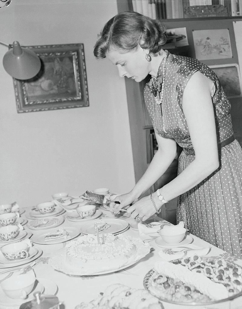 ingrid bergman cutting a cake at home