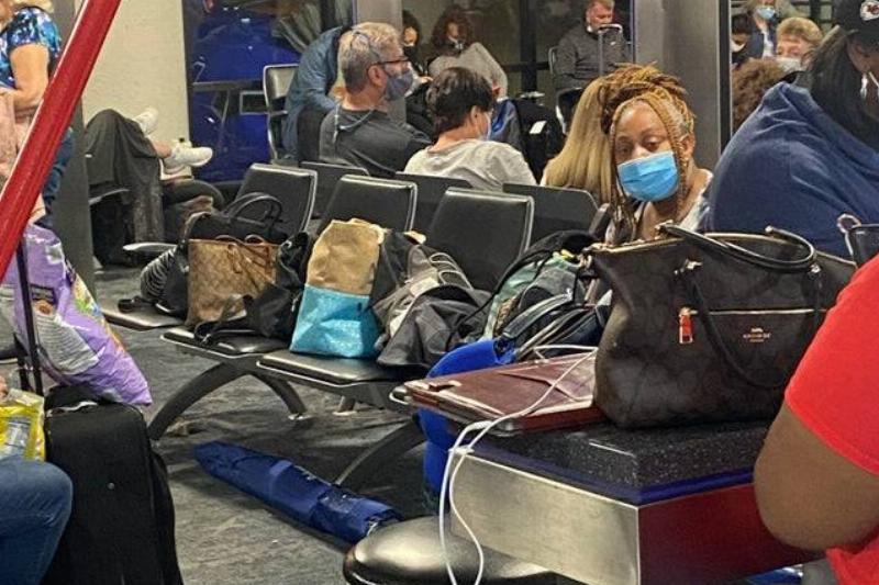 Bags Need A Space Bags on seats in an airport