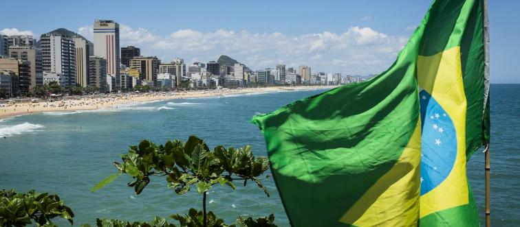 The Brazilian flag flutters in the wind at the end of Leblon and Ipanema beaches in Rio de Janeiro.