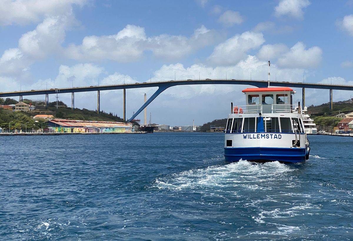 A boat moves across Sint Anna Bay towards the Queen Juliana bridge, in Willemstad, Curacao, in the Dutch Caribbean, on March 5, 2020. - The Queen Juliana Bridge is 500m long and 56m height. 