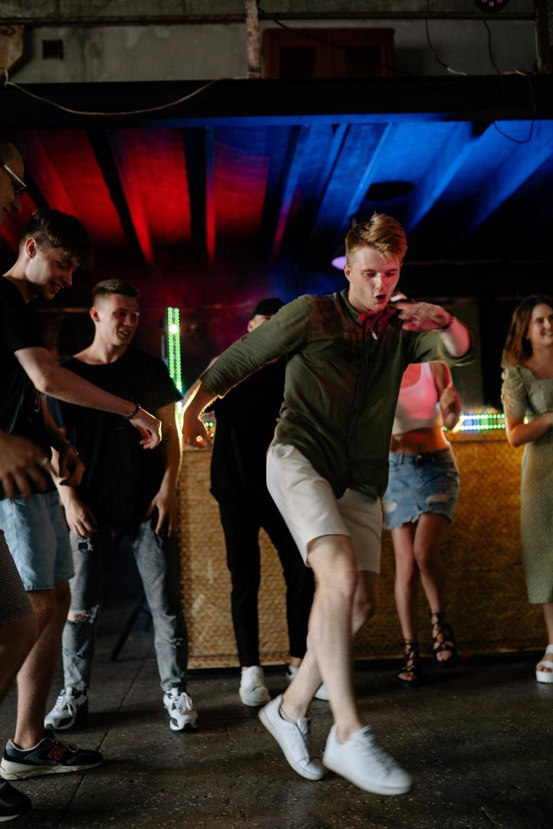 Man dancing in group with friends