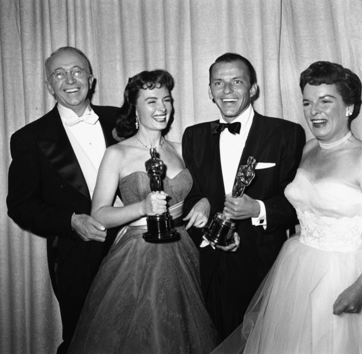 Actors Frank Sinatra (second right) and Donna Reed (second left) holding their supporting actor Oscars, both for the film 'From Here to Eternity', with presenters Walter Brennan and Mercedes McCambridge, at the 26th Academy Awards, March 25th 1954.