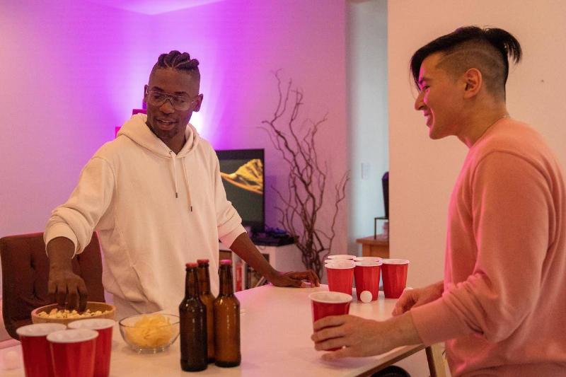 Men playing beer pong at party