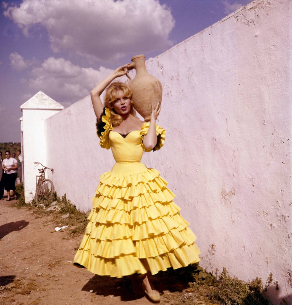 Portrait of French actress Brigitte Bardot in Spanish dress holding a jug, circa 1960s