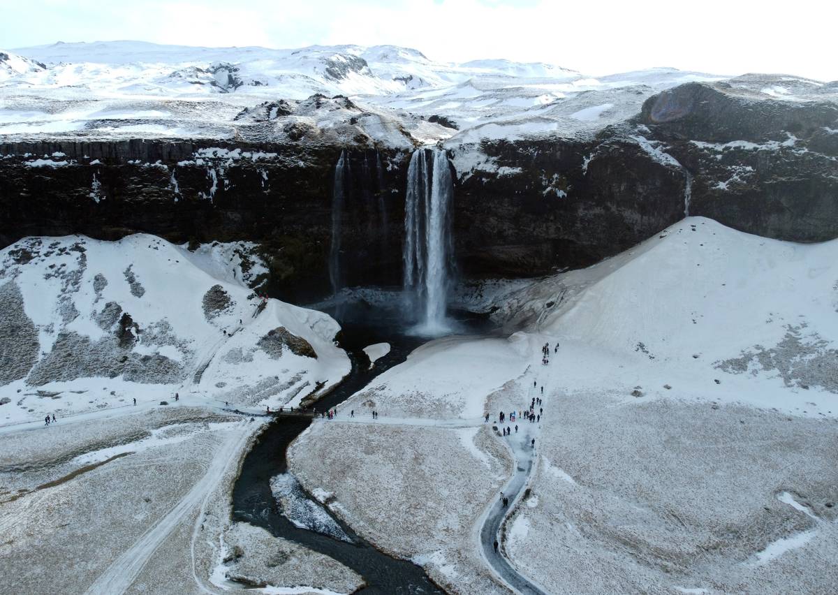 Seljalandsfoss waterfall in the South Region in Iceland by Route 1. The waterfall drops 60 m (197 ft) and is part of the Seljalands River that has its origin in the volcano glacier Eyjafjallajokull
