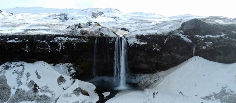 Seljalandsfoss waterfall in the South Region in Iceland by Route 1. The waterfall drops 60 m (197 ft) and is part of the Seljalands River that has its origin in the volcano glacier Eyjafjallajokull