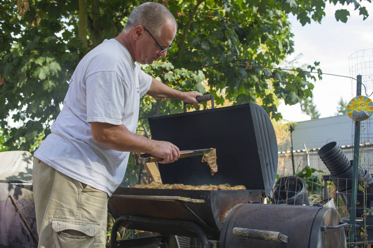 man cooking over bbq grill