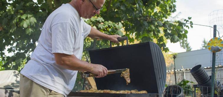 man cooking over bbq grill