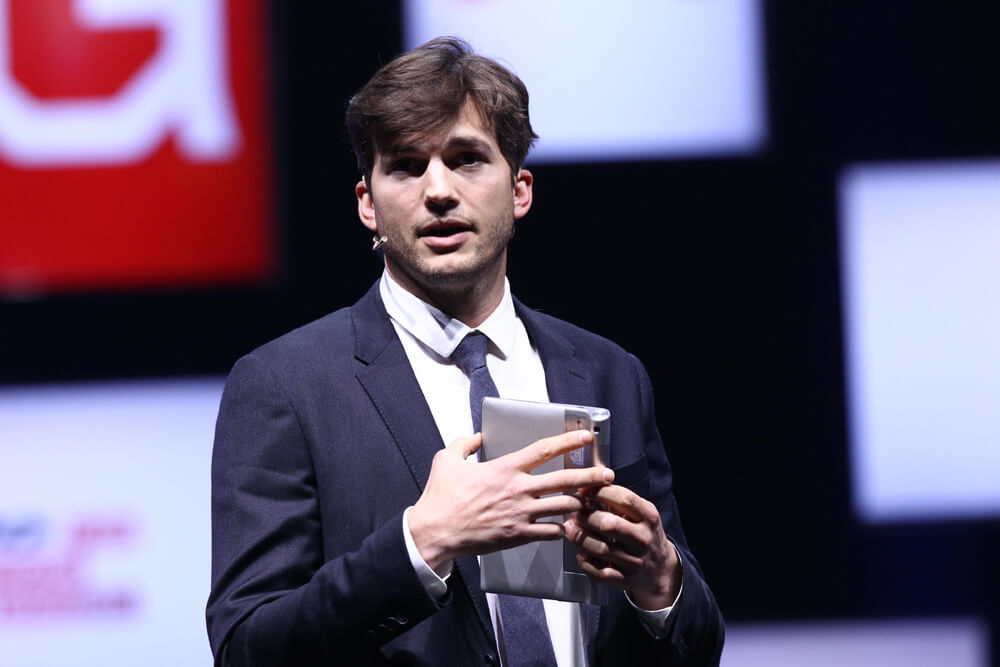 Ashton Kutcher holds tablet