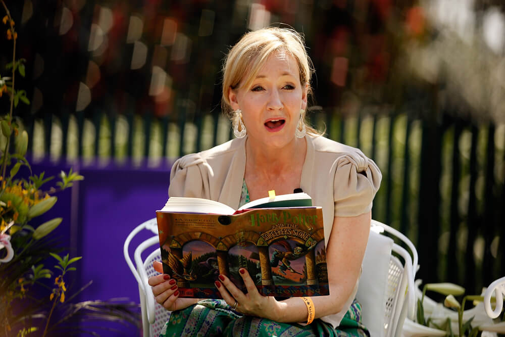 JK Rowling reads from Harry Potter seated outside