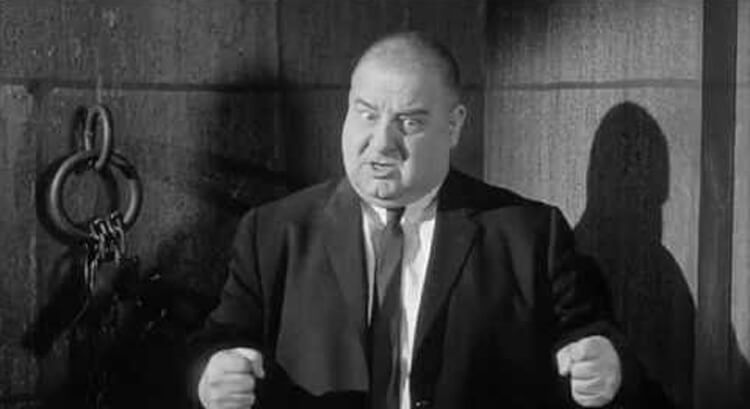 Joe DeRita, Curly Joe on set of The Three Stooges looking angry with fists balled