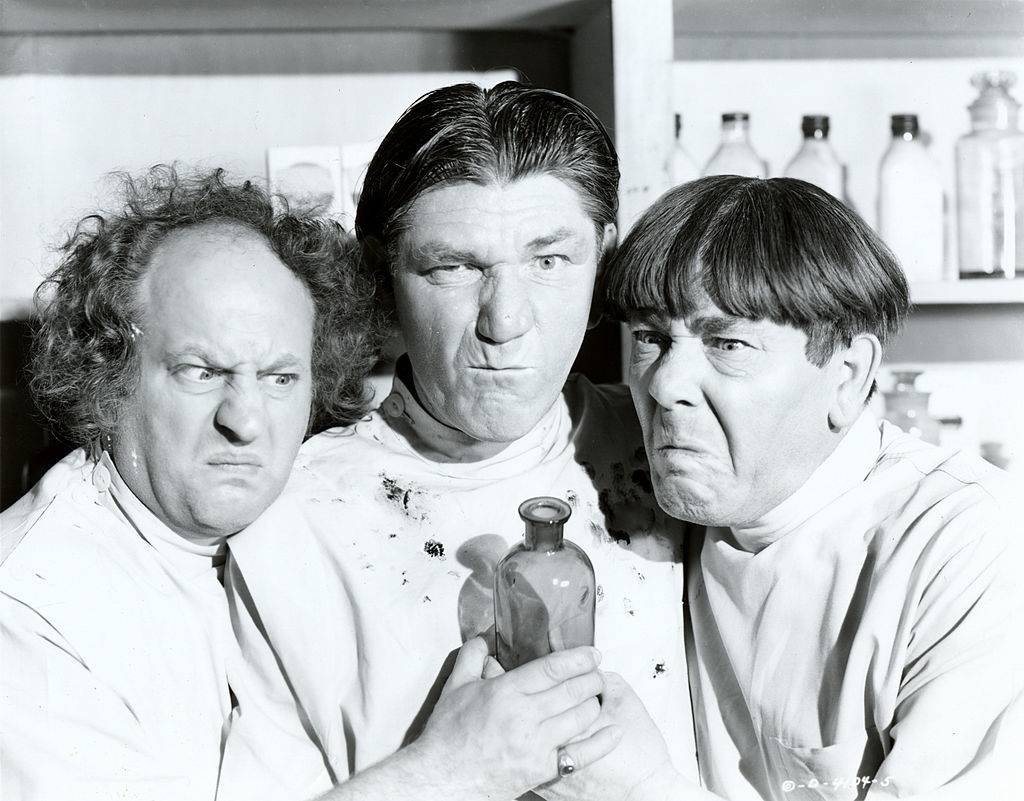 Two men make faces at camera while filming three stooges 