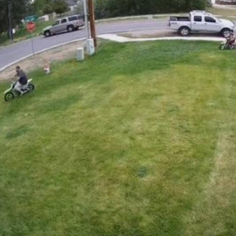 dirtbiking on a lawn people dirt biking across a lawn