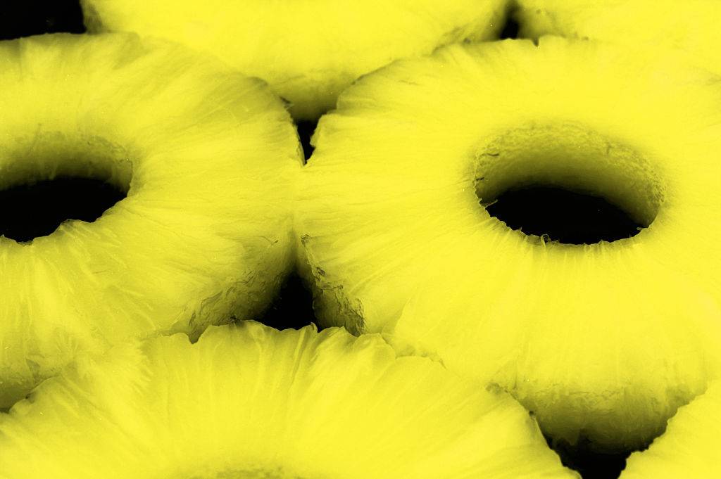 Pineapple slices on black background