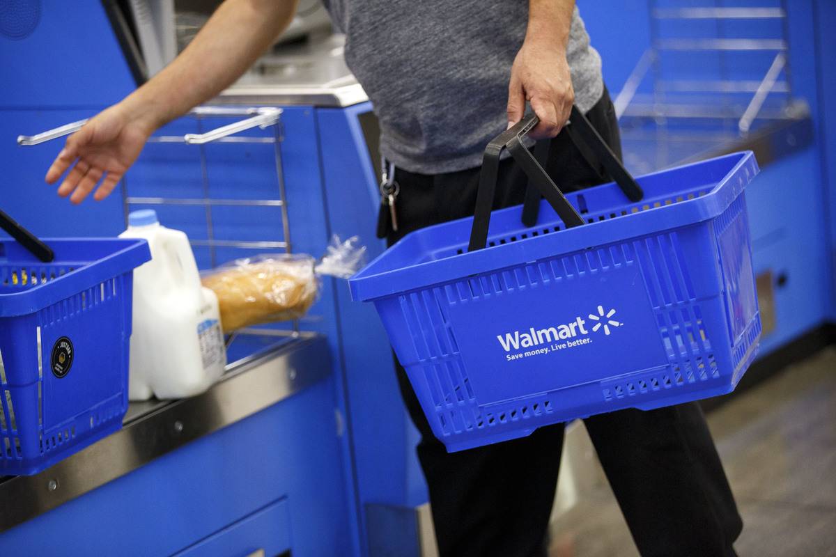 Wal-Mart A customer uses a self-checkout kiosk at a Wal-Mart Stores Inc. location in Burbank, California, U.S.