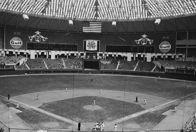 (Original Caption) Houston, Texas: Jim Beauchamp of the Houston Astros is congratulated at home plate by teammates after hitting the team's first home run in Houston's new domed stadium, as the huge scoreboard in center field goes off.