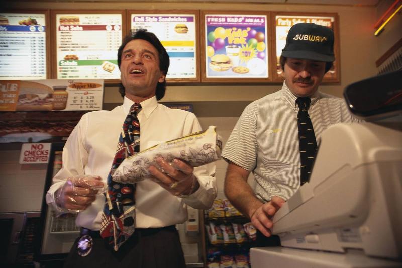 Subway founder Fred DeLuca (left) helps out during his visit to an Anaheim Subway franchise