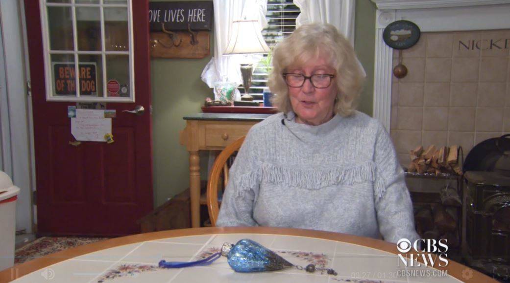 woman sitting at table with ornament