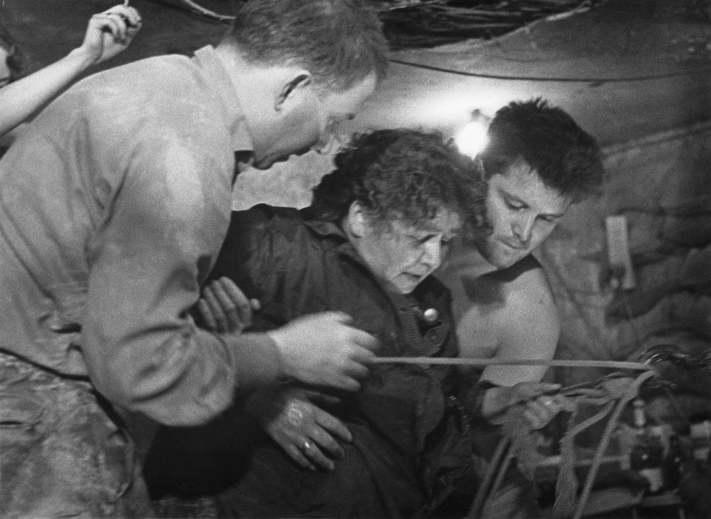 75 year old woman being helped in tunnel
