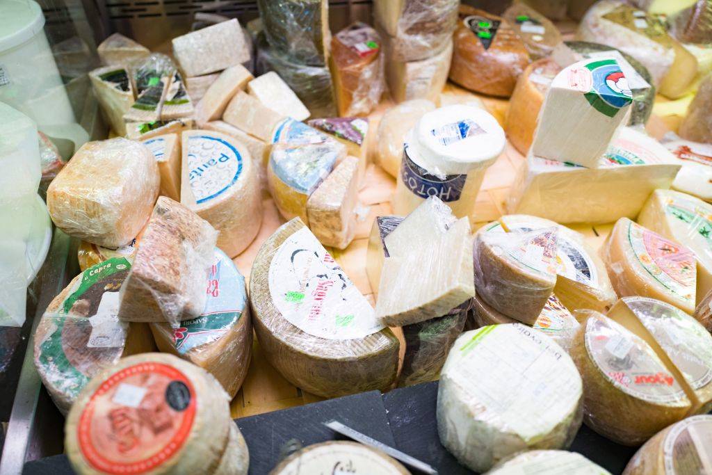 Close-up of artisan cheeses on display