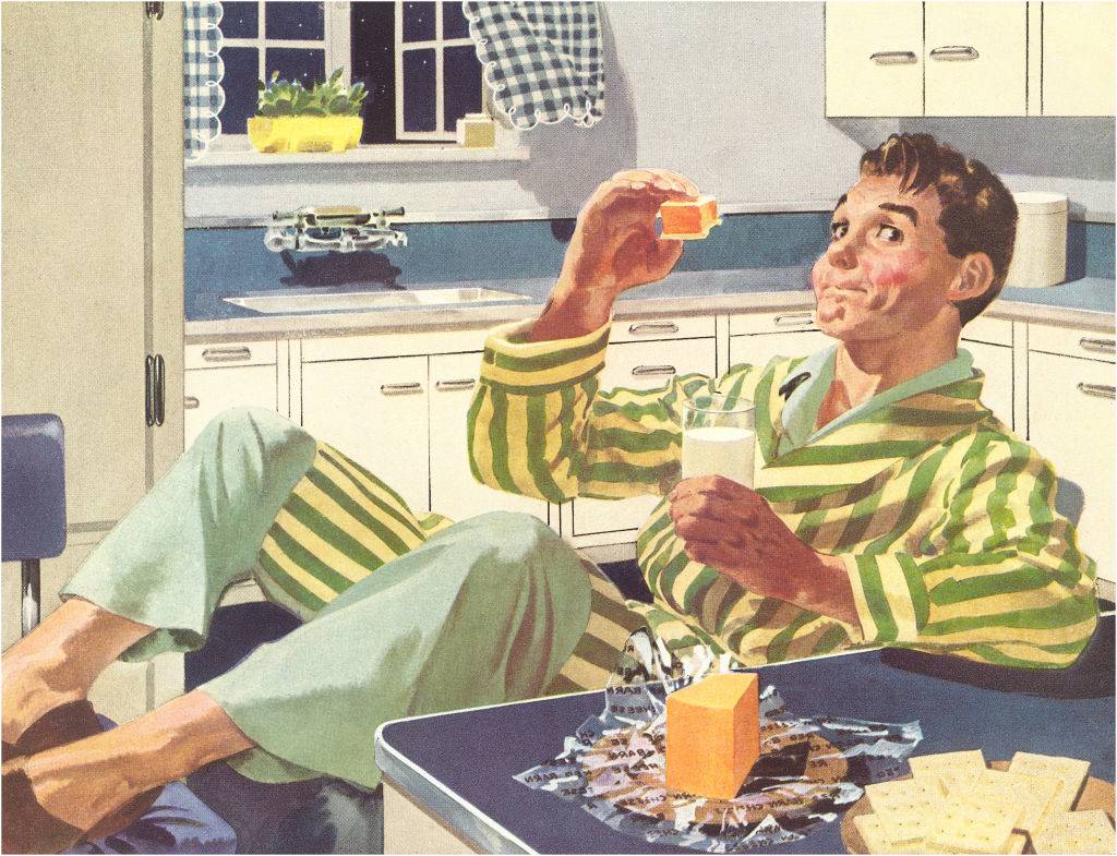 A man appears to have discovered the joys of eating cheese and crackers in the middle of the night