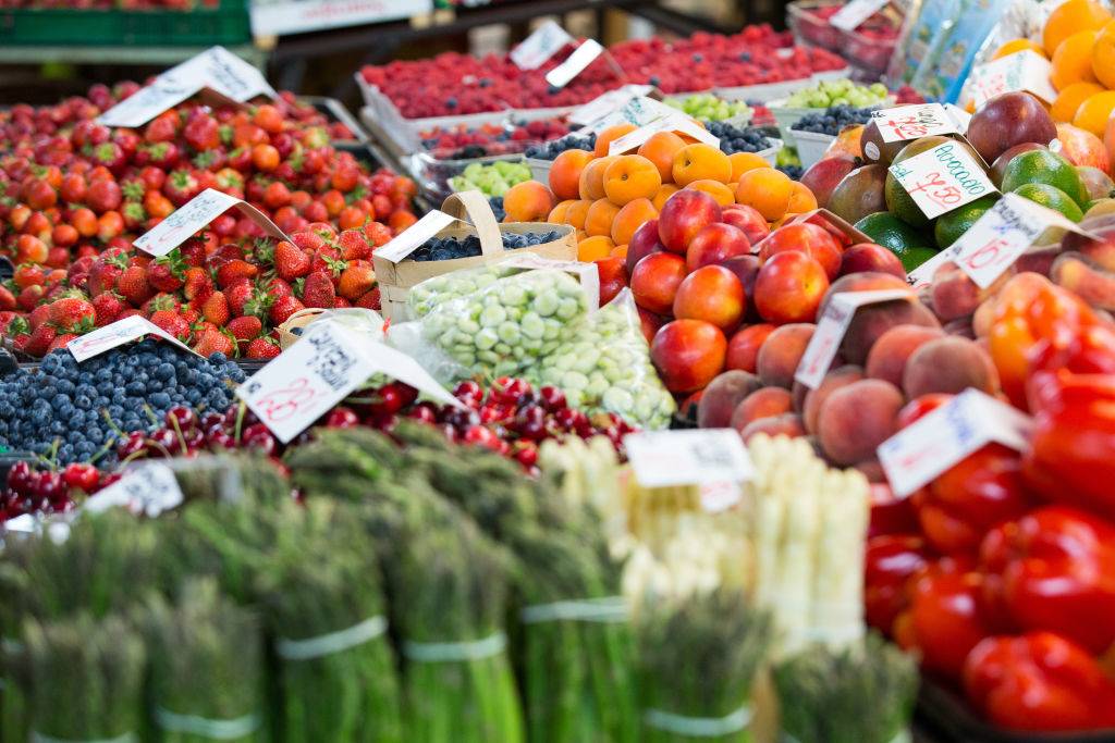 View of various vegetables and fruits displayed on the shelves