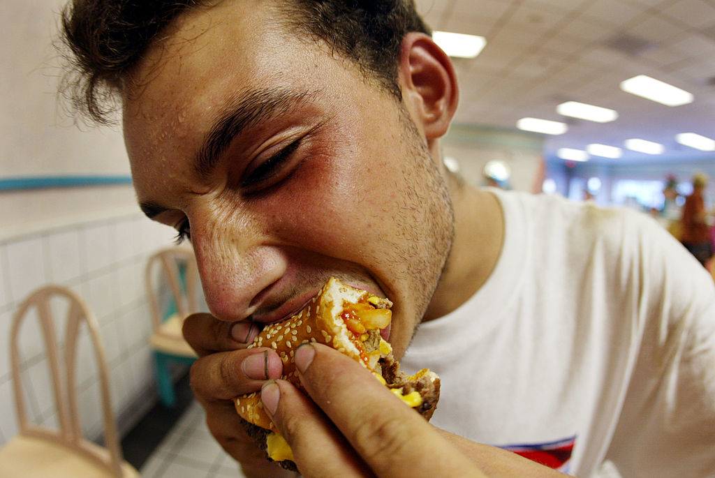 man eating a hamburger