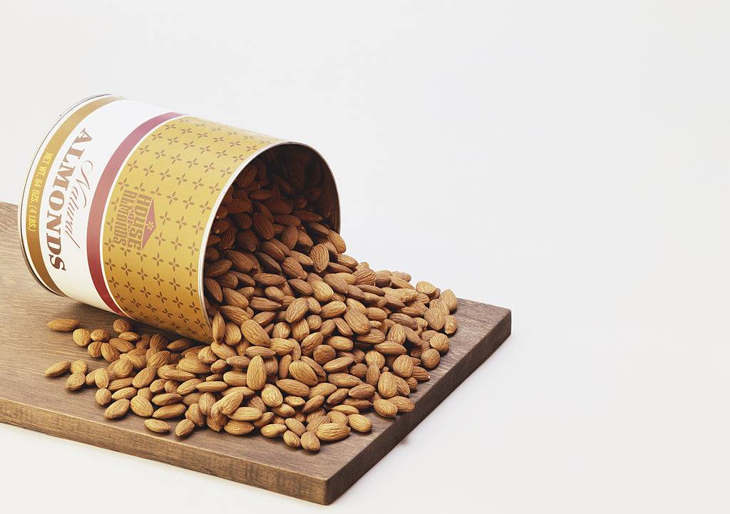 Almonds spilling from tin, close-up