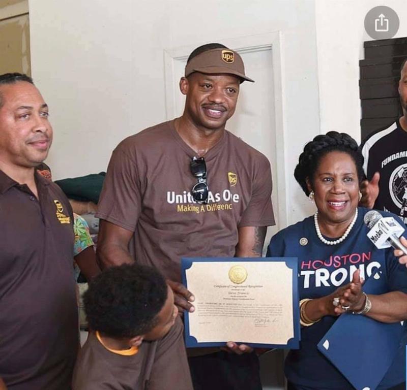 steve francis presenting award to charity dressed in UPS shirt
